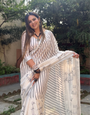 Elegant Off-White Pure Linen Digital Printed Saree with Striped Design and Unique Black Motif Pallu ā Comes with Blouse Piece and Tassels