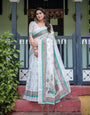 Ivory Pure Cotton Linen Saree with Elephant Motif and Floral Pattern, Green and Pink Borders, and Tassels on Edges.