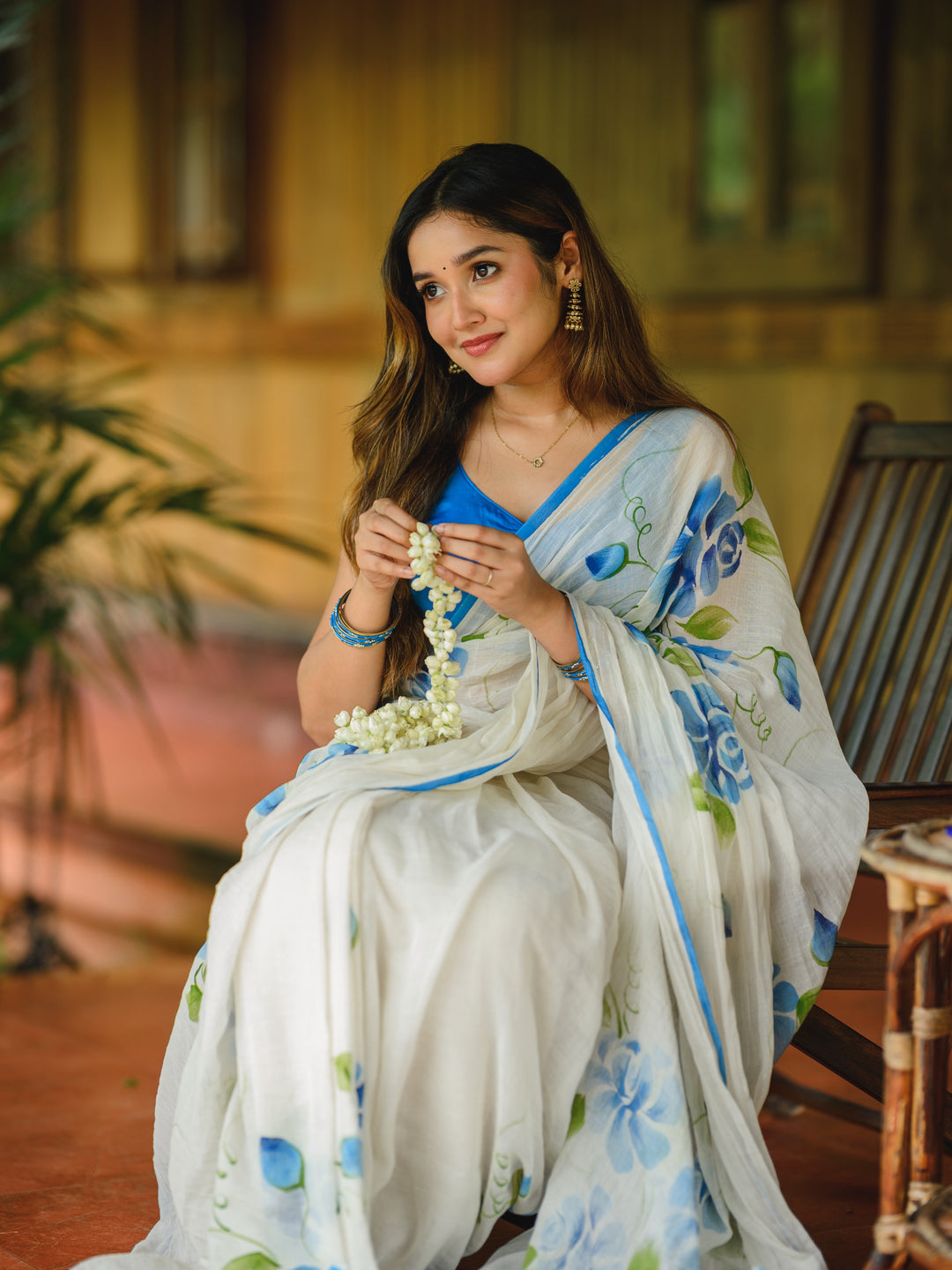Ivory Chiffon Floral Printed Saree with Blue Rose Print, Contrast Border & Tassel Edges
