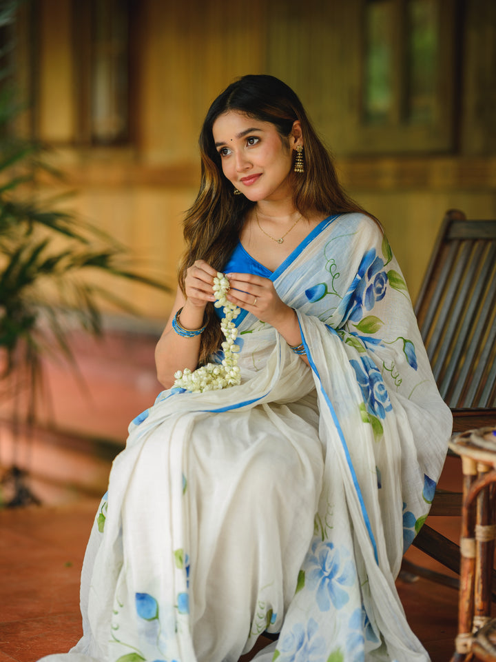 Ivory Chiffon Floral Printed Saree with Blue Rose Print, Contrast Border & Tassel Edges