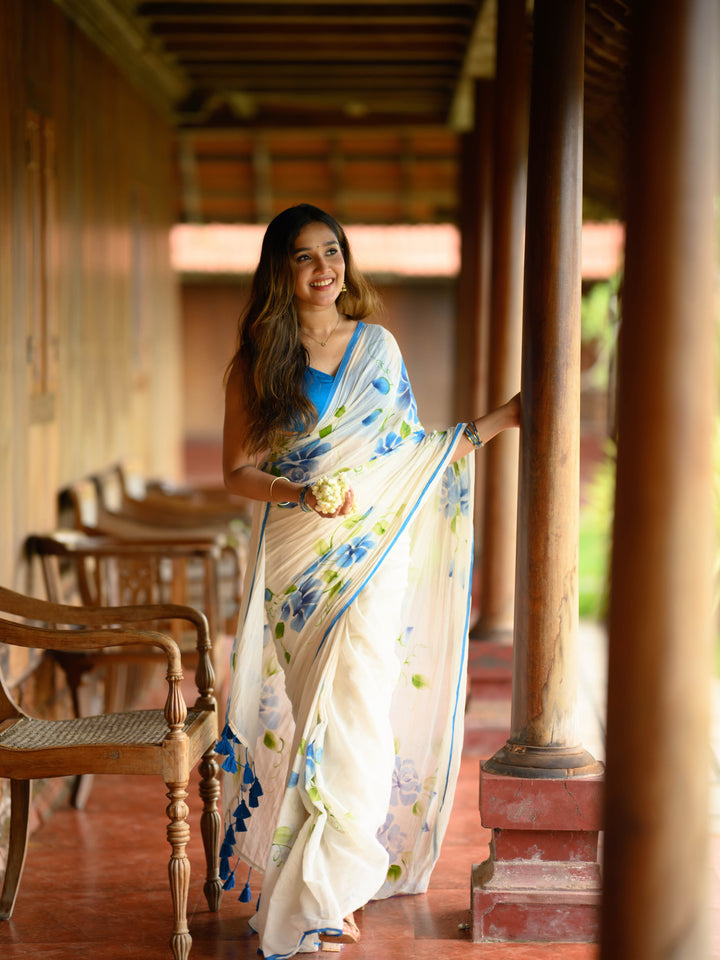Ivory Chiffon Floral Printed Saree with Blue Rose Print, Contrast Border & Tassel Edges