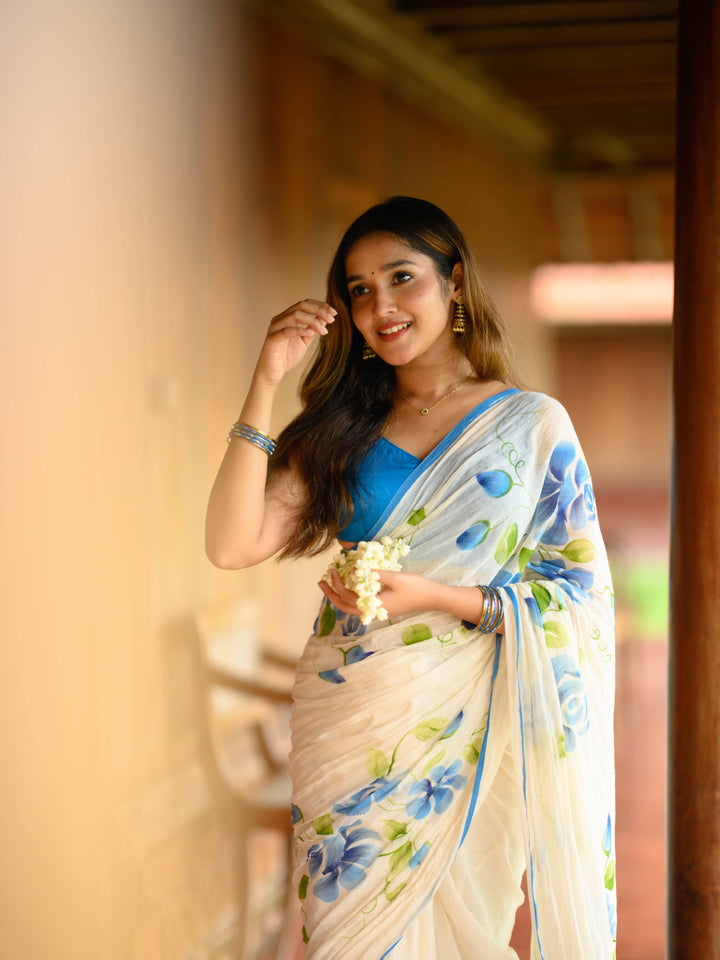 Ivory Chiffon Floral Printed Saree with Blue Rose Print, Contrast Border & Tassel Edges