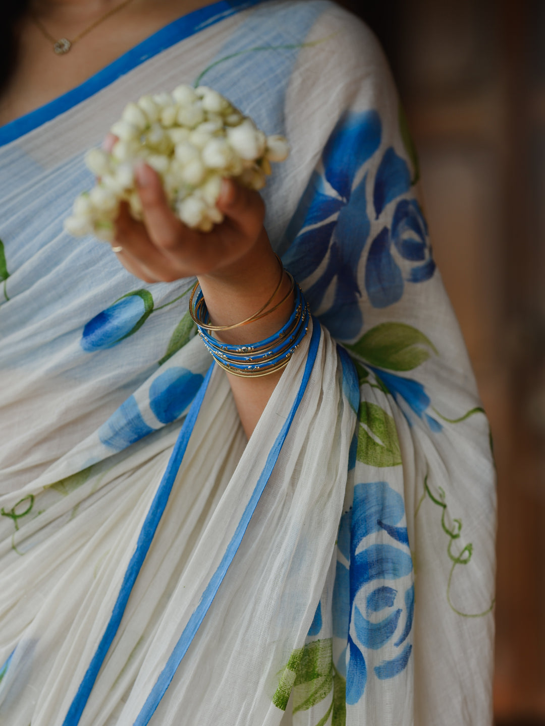 Ivory Chiffon Floral Printed Saree with Blue Rose Print, Contrast Border & Tassel Edges