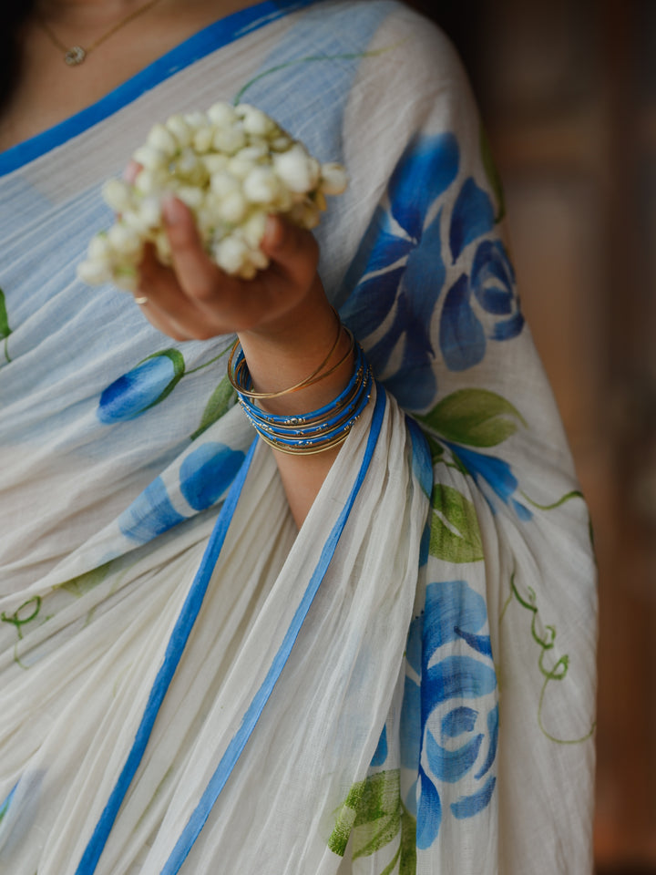 Ivory Chiffon Floral Printed Saree with Blue Rose Print, Contrast Border & Tassel Edges