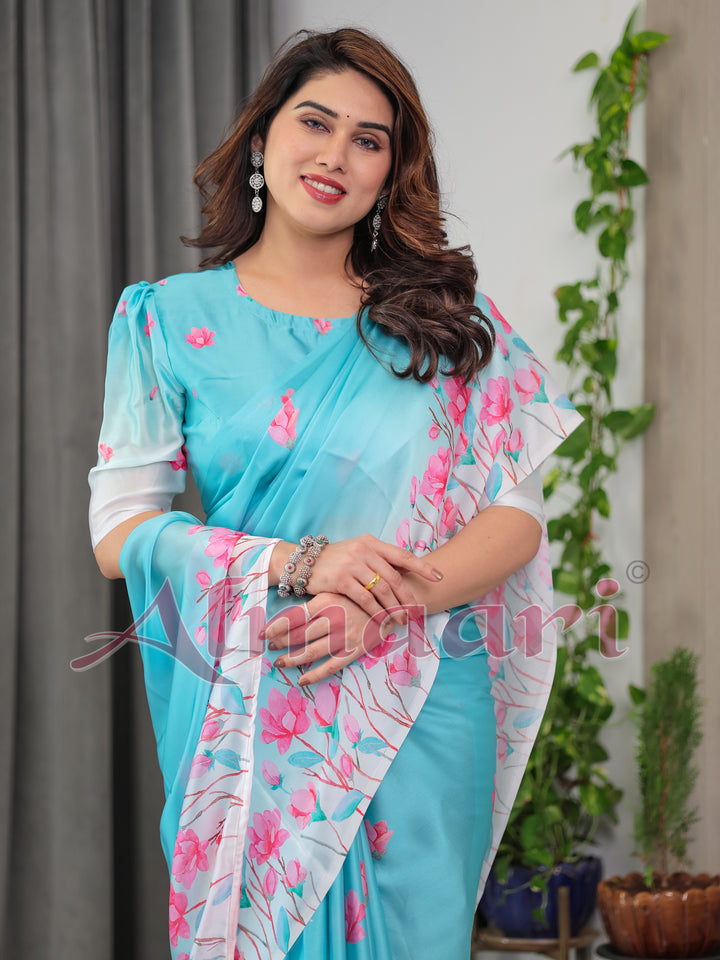 Aqua Blue Satin Georgette Pink Floral Printed Saree with Attached Blouse – Soft Pastel Designer Saree for Elegant & Festive Wear