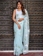 Pastel Blue Georgette Saree with Hand-Painted White Floral Motifs & Green Leaves – Attached Blouse – 5.5 Meters