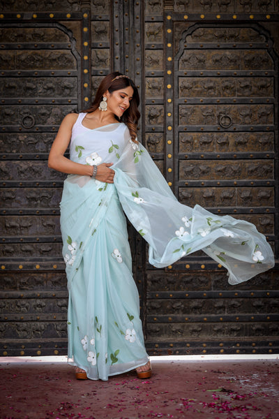 Pastel Blue Georgette Saree with Hand-Painted White Floral Motifs & Green Leaves – Attached Blouse – 5.5 Meters