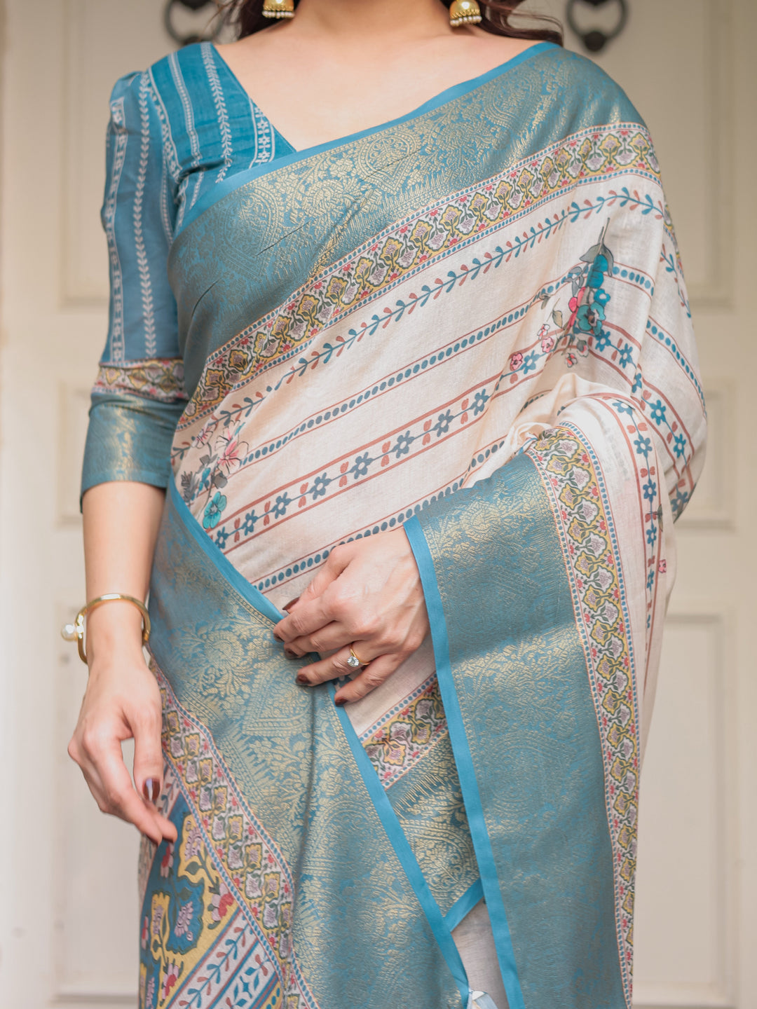 Off-White & Aqua Teal Traditional Printed Saree with Rich Zari Border & Tassels – Elegant Ethnic Festive Wear