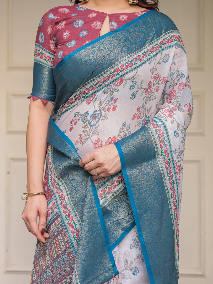 Ivory Floral Printed Saree with Rose Pink & Teal Blue Zari Border & Tassels – Elegant Festive Ethnic Wear