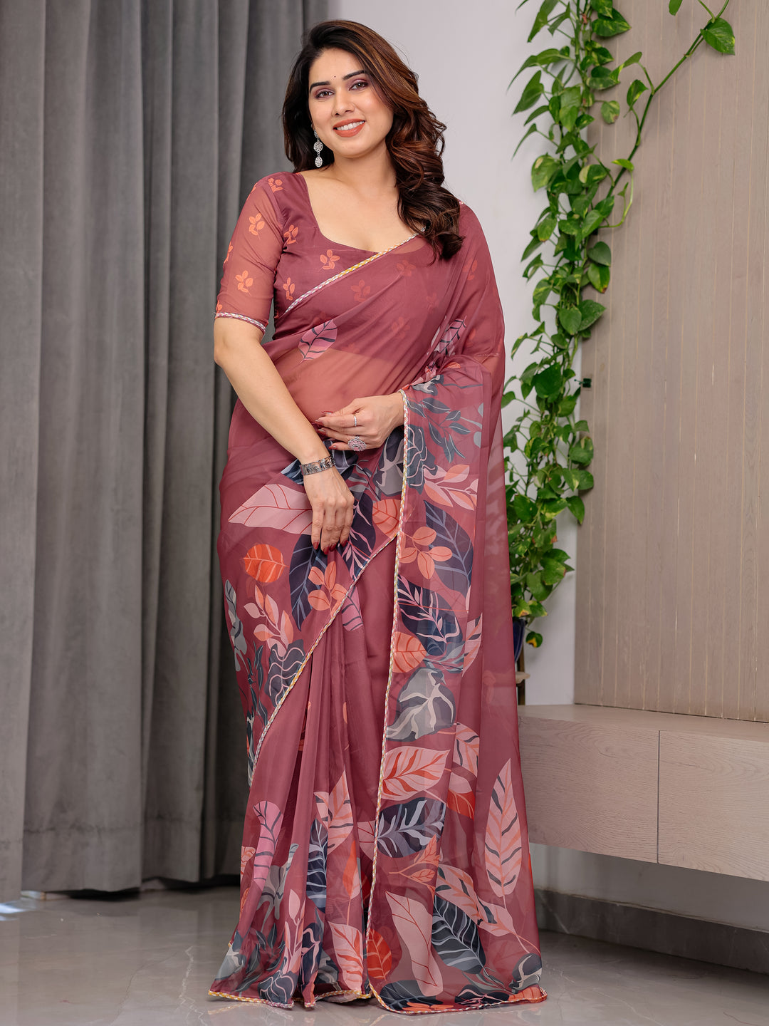 Rust Wine Printed Organza Saree with Tropical Leaf Border | Designer Lightweight Sheer Organza Saree with Botanical Prints & Attached Blouse Piece | Elegant Festive & Party Wear Saree